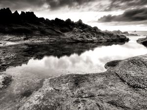 Preview wallpaper sea, stones, coast, rocks, despondency, black-and-white