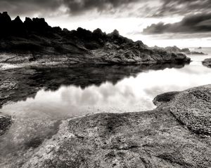 Preview wallpaper sea, stones, coast, rocks, despondency, black-and-white