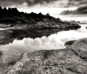 Preview wallpaper sea, stones, coast, rocks, despondency, black-and-white