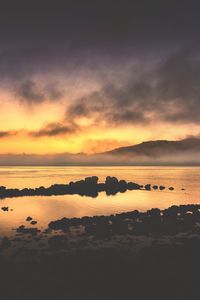 Preview wallpaper sea, stones, hills, clouds, evening