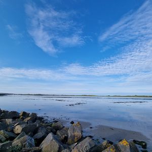 Preview wallpaper sea, stones, horizon, clouds, sky, nature