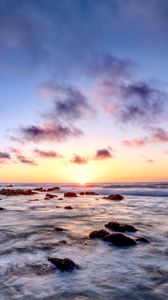 Preview wallpaper sea, stones, horizon, sunset, clouds, nature