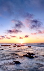 Preview wallpaper sea, stones, horizon, sunset, clouds, nature