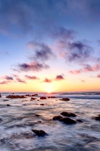 Preview wallpaper sea, stones, horizon, sunset, clouds, nature