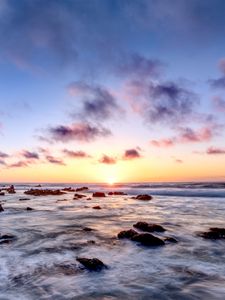 Preview wallpaper sea, stones, horizon, sunset, clouds, nature