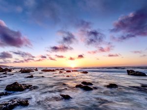 Preview wallpaper sea, stones, horizon, sunset, clouds, nature