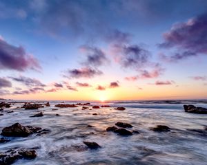 Preview wallpaper sea, stones, horizon, sunset, clouds, nature