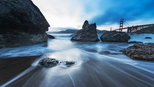 Preview wallpaper sea, stones, morning, fog, bridge, movement, stream