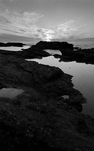 Preview wallpaper sea, stones, reefs, dark, black and white, nature