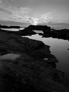 Preview wallpaper sea, stones, reefs, dark, black and white, nature