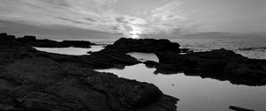 Preview wallpaper sea, stones, reefs, dark, black and white, nature