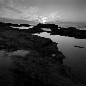 Preview wallpaper sea, stones, reefs, dark, black and white, nature