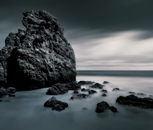 Preview wallpaper sea, stones, rocks, fog, horizon, clouds