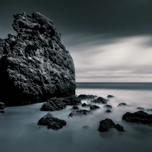 Preview wallpaper sea, stones, rocks, fog, horizon, clouds