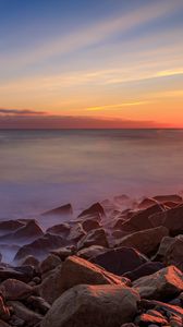 Preview wallpaper sea, stones, stone, coast, horizon, sunset