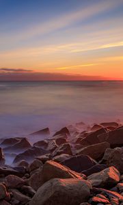 Preview wallpaper sea, stones, stone, coast, horizon, sunset
