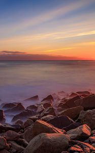 Preview wallpaper sea, stones, stone, coast, horizon, sunset