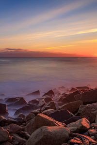 Preview wallpaper sea, stones, stone, coast, horizon, sunset