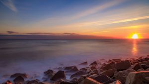 Preview wallpaper sea, stones, stone, coast, horizon, sunset