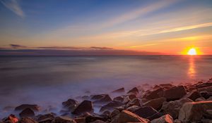 Preview wallpaper sea, stones, stone, coast, horizon, sunset