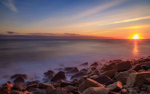 Preview wallpaper sea, stones, stone, coast, horizon, sunset