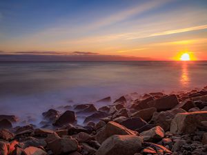 Preview wallpaper sea, stones, stone, coast, horizon, sunset