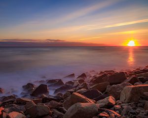 Preview wallpaper sea, stones, stone, coast, horizon, sunset