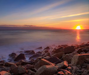 Preview wallpaper sea, stones, stone, coast, horizon, sunset