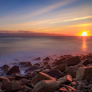 Preview wallpaper sea, stones, stone, coast, horizon, sunset