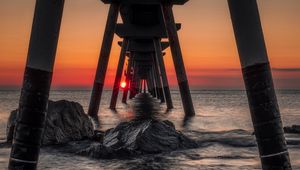 Preview wallpaper sea, stones, sunset, construction