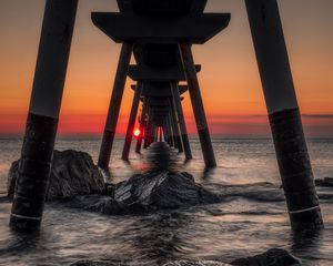 Preview wallpaper sea, stones, sunset, construction