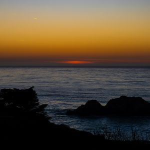 Preview wallpaper sea, stones, sunset, horizon, dark