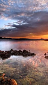 Preview wallpaper sea, stones, water, transparent, decline, evening, sky, beacon