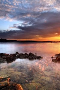 Preview wallpaper sea, stones, water, transparent, decline, evening, sky, beacon