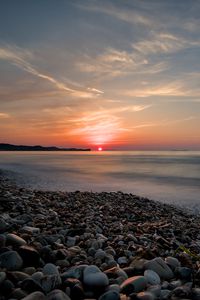 Preview wallpaper sea, sunrise, pebbles, shore, horizon