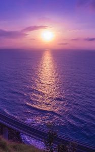 Preview wallpaper sea, sunset, bridge, horizon, purple, lilac
