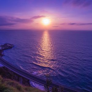 Preview wallpaper sea, sunset, bridge, horizon, purple, lilac