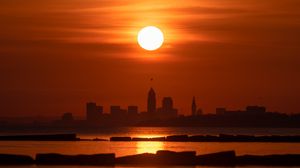 Preview wallpaper sea, sunset, city, silhouettes, dark