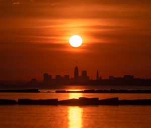Preview wallpaper sea, sunset, city, silhouettes, dark