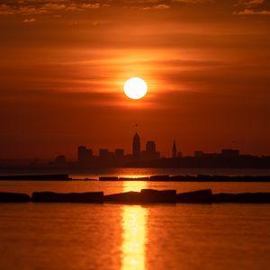 Preview wallpaper sea, sunset, city, silhouettes, dark