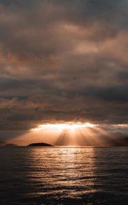 Preview wallpaper sea, sunset, clouds, sunbeams, light
