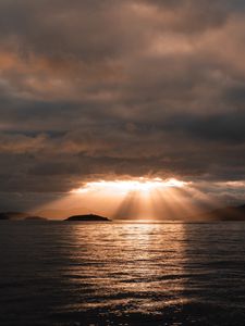 Preview wallpaper sea, sunset, clouds, sunbeams, light