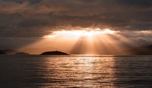 Preview wallpaper sea, sunset, clouds, sunbeams, light
