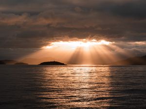 Preview wallpaper sea, sunset, clouds, sunbeams, light