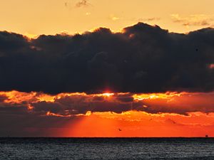 Preview wallpaper sea, sunset, clouds, sun, dusk
