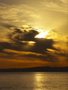 Preview wallpaper sea, sunset, clouds, horizon, mountains
