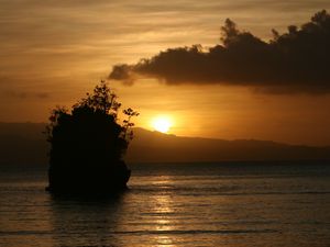 Preview wallpaper sea, sunset, dark, island, rock