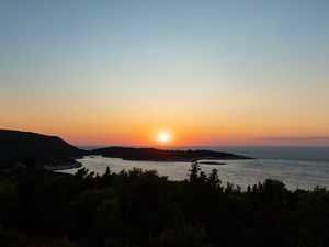 Preview wallpaper sea, sunset, horizon, island, landscape, nature