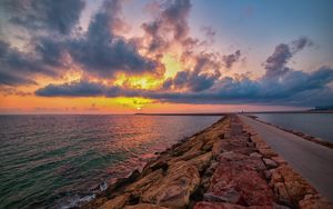 Preview wallpaper sea, sunset, horizon, stones, road