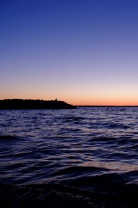 Preview wallpaper sea, sunset, loneliness, alone, silhouette, rocks